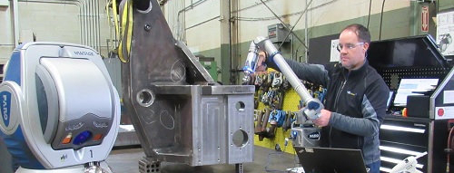 Two workers in hard hats reading a chart